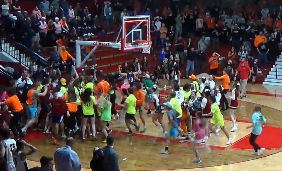 Gibault fans storm the court and celebrate with their team after a 3-point buzzer-beater sent them to the state finals with a 45-44 comeback win over Illini Bluffs in the IHSA Class 1A Supersectional at Jacksonville on Monday, March 6, 2023.