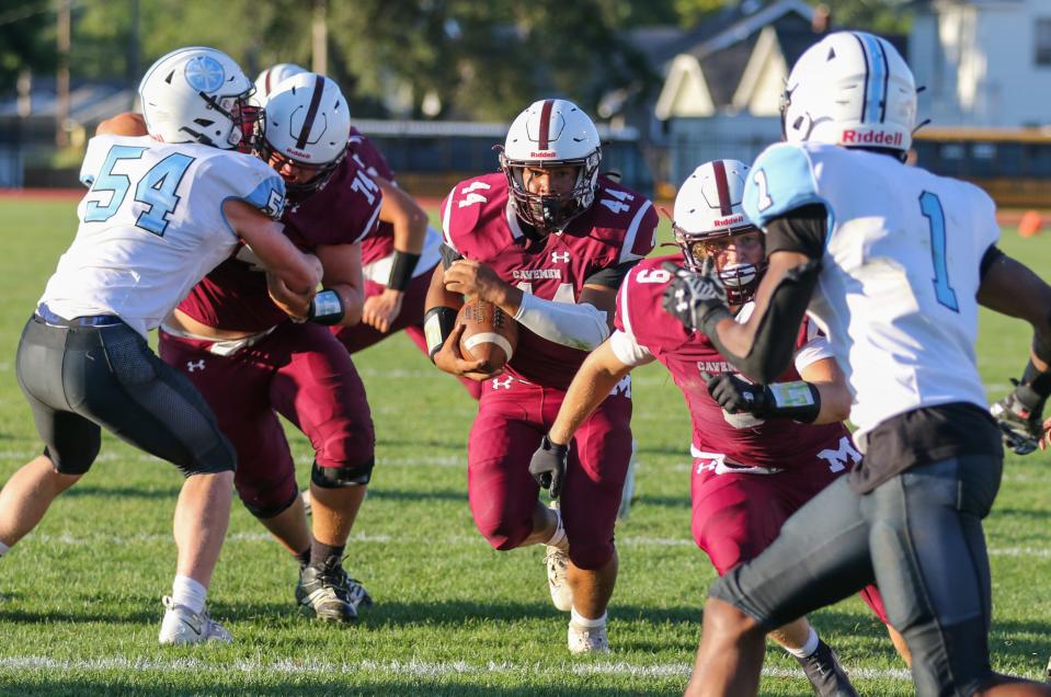 Mishawaka’s Chase Gooden (44) runs up the middle for the game’s first touchdown during Friday night’s game against Saint Joseph at Mishawaka.
