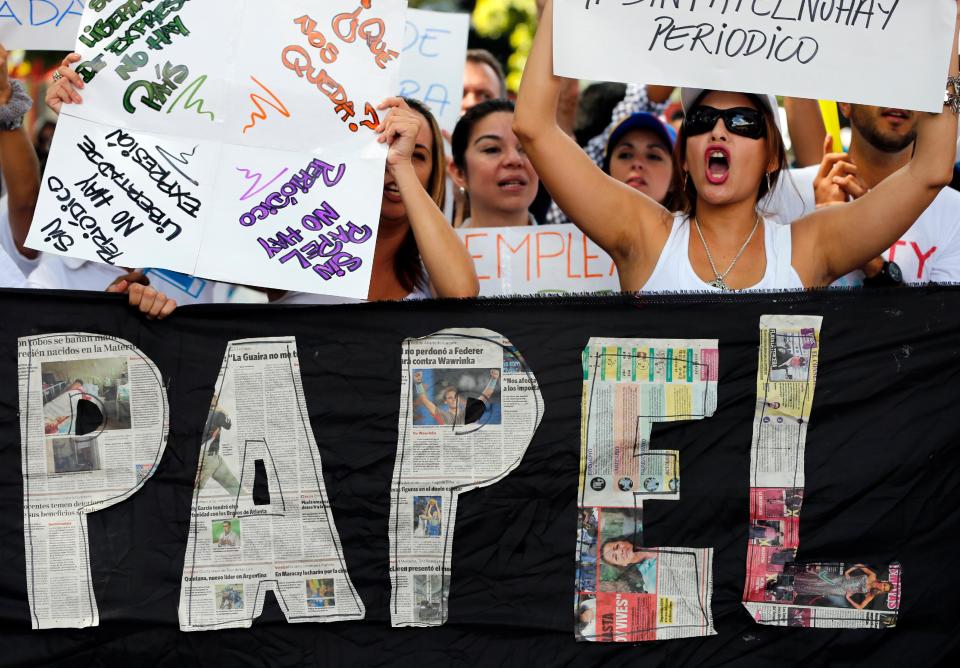 Employees of the newspaper El Nacional shout slogans against Venezuela's President Nicolas Maduro during a protest outside the Cadivi agency, which controls foreign currency in Caracas, Venezuela, Tuesday, Jan. 28, 2014. While newspapers have been beset for years by currency controls that make it difficult to import supplies, El Nacional is scrambling for newsprint as worsening shortages threaten to take several publications out of circulation in the coming weeks as reserves of newsprint have fallen to an all-time low. (AP Photo/Fernando Llano)