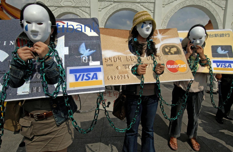 Local consumers who are in credit card debt, referred to as "credit card slaves", take part in a demonstration calling for the government to pass a law to help people owing money to banks, June 2, 2007, in Taipei. (Photo credit: SAM YEH/AFP via Getty Images)