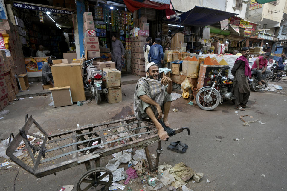 A laborer waits for work at a market, in Karachi, Pakistan, Thursday, July 13, 2023. Pakistan’s finance minister on Thursday said the International Monetary Fund deposited a much-awaited first installment of $1.2 billion with the country’s central bank under a recently signed bailout aimed at enabling the impoverished Islamic nation to avoid defaulting on its debt repayments. (AP Photo/Fareed Khan)