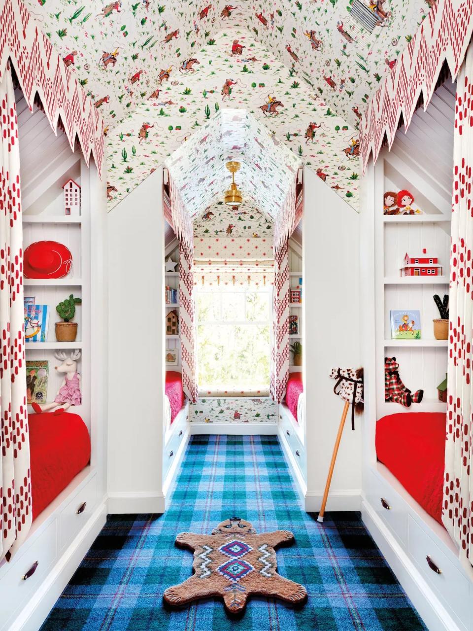 Kids' room covered in vintage cowboy-print wallpaper and blue tartan carpet. 