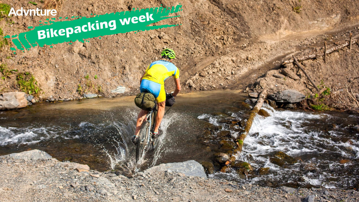  Ultra bikepacker riding across river 