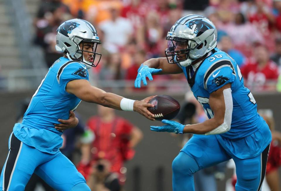 Dec 3, 2023; Tampa, Florida, USA; Carolina Panthers quarterback Bryce Young (9) hands the ball off to running back Chuba Hubbard (30) against the Tampa Bay Buccaneers during the first quarter at Raymond James Stadium. Mandatory Credit: Kim Klement Neitzel-USA TODAY Sports