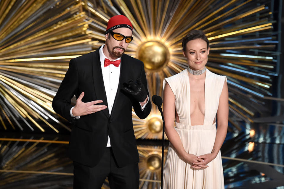 Sacha Baron Cohen and Olivia Wilde speak onstage during the 88th Annual Academy Awards at the Dolby Theatre on February 28, 2016 in Hollywood, California.  