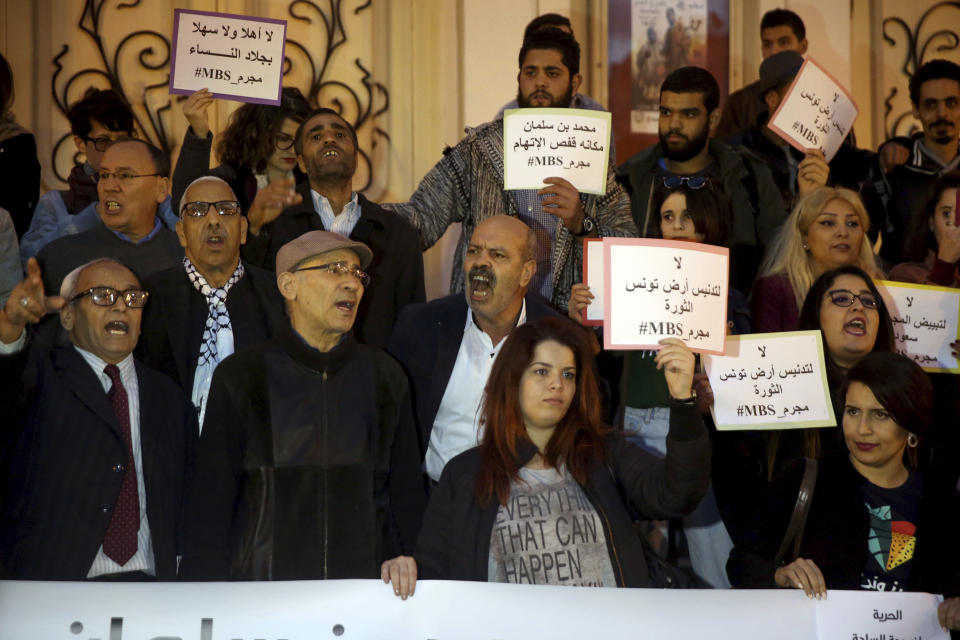 Activists hold up placards that read "No to repression of freedom of expression #MBS assassin" on the eve of Saudi Crown Prince Mohammed bin Salman's official visit to Tunisia, during a protest to denounce the killing of Saudi journalist Jamal Khashoggi, in downtown Tunis, Monday, Nov. 26, 2018. (AP Photo/Hassene Dridi)