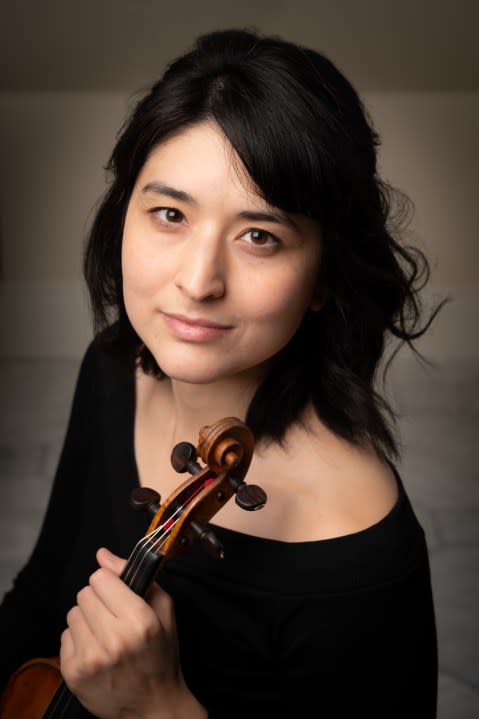 Violinist Naha Greenholtz is concertmaster of the QC Symphony Orchestra.