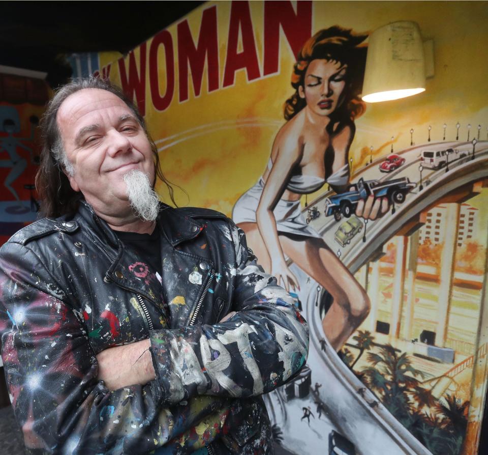 Art Army founder Perego stands in front of a mural he created at The Grind & Kona Tiki Bar in Ormond Beach on Monday. On Tuesday, he will be presented with a President's Lifetime Achievement Award.