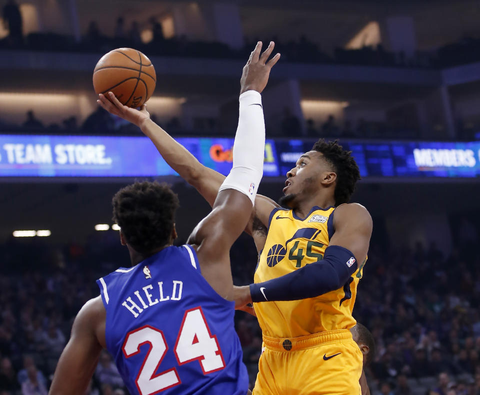 Utah Jazz guard Donovan Mitchell, right, goes to the basket against Sacramento Kings guard Buddy Hield during the first quarter of an NBA basketball game in Sacramento, Calif., Friday, Nov. 1, 2019. (AP Photo/Rich Pedroncelli)