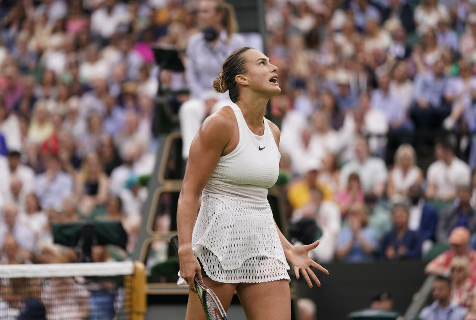 Aryna Sabalenka of Belarus reacts as she plays Tunisia's Ons Jabeur in a women's singles semifinal match on day eleven of the Wimbledon tennis championships in London, Thursday, July 13, 2023. (AP Photo/Alberto Pezzali)
