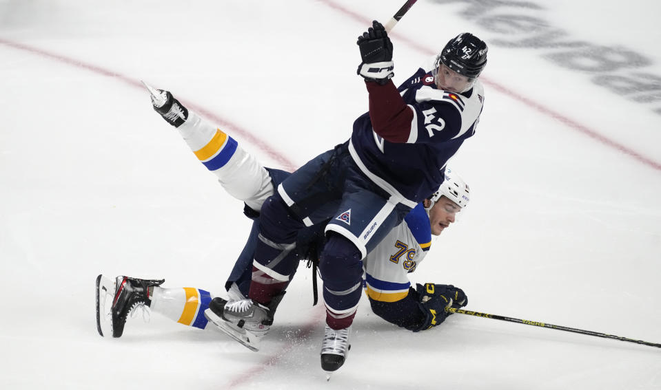 Colorado Avalanche defenseman Josh Manson, front, wrestles St. Louis Blues left wing Sammy Blais to the ice as he drives to the net in the first period of an NHL hockey game, Wednesday, Nov. 1, 2023, in Denver. (AP Photo/David Zalubowski)