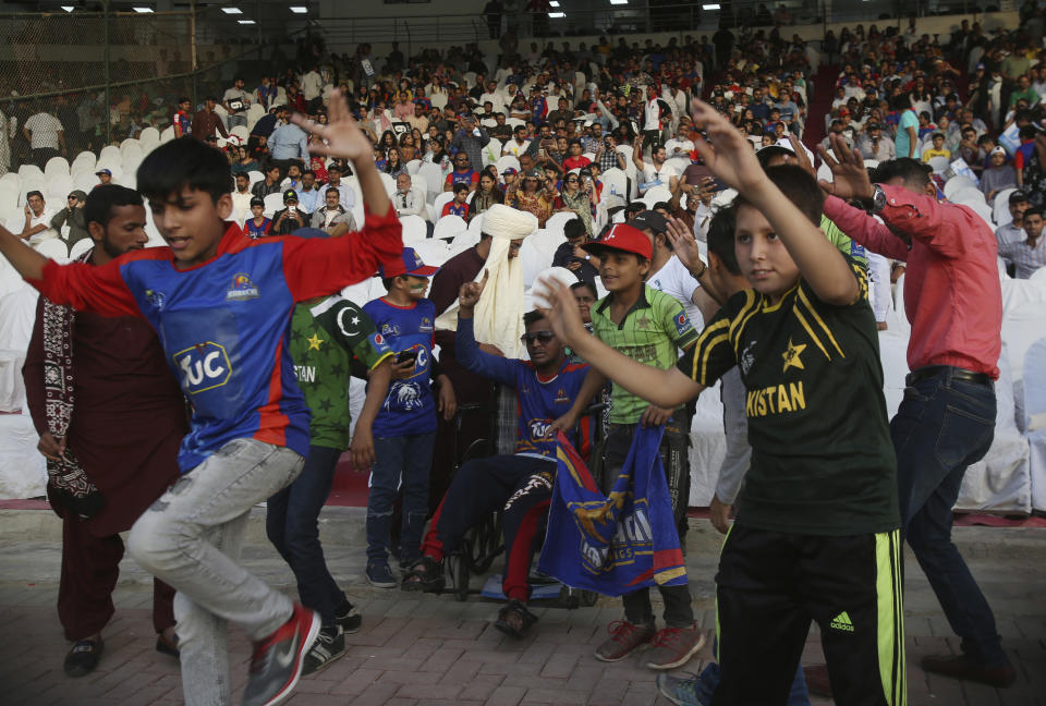 Pakistani cricket fans celebrate the victory of Islamabad United against Karachi Kings, in the Pakistan Super League playoff at National Stadium in Karachi, Pakistan, Thursday, March 14, 2019. (AP Photo/Fareed Khan)