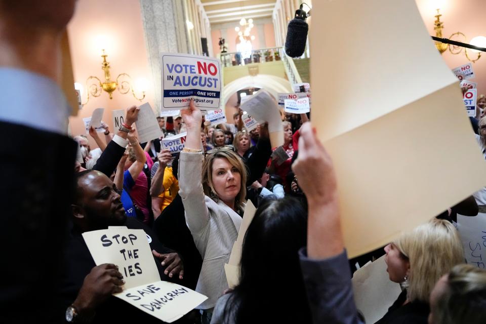 May 10, 2023; Columbus, Ohio, USA;  House Minority Leader Allison Russo speaks with protesters in the rotunda of the Ohio Statehouse with fellow Democrat representatives holding up hand-drawn signs on manilla folders chanting “one person one vote” following a vote on whether to create an August special election for a resolution that would increase the voter threshold to 60 percent for constitutional amendments. Mandatory Credit: Adam Cairns-The Columbus Dispatch