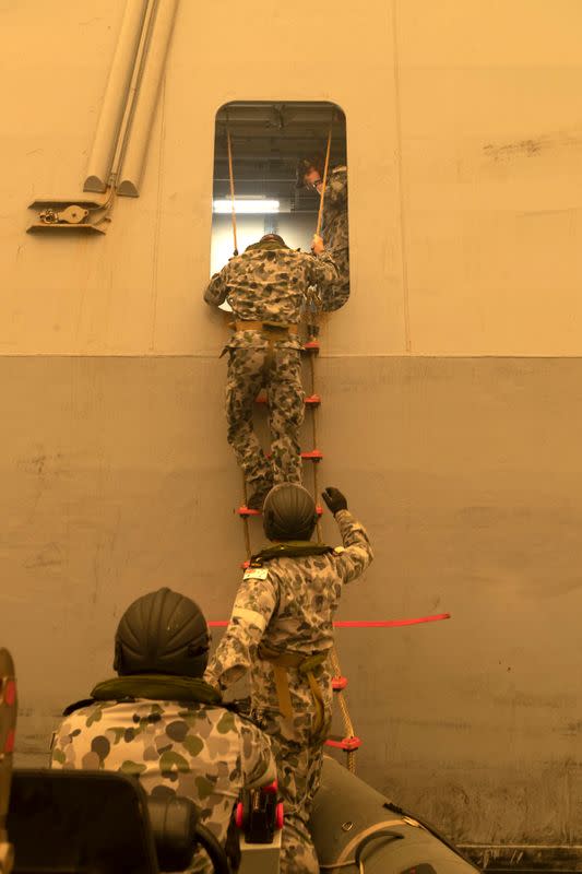 A supplied image shows HMAS Choules' Fast Recovery Craft embarking personnel in order to drop them ashore in Mallacoota