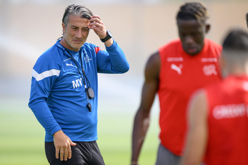 Switzerland's head coach Murat Yakin, left, attends an open training session of Swiss national soccer team in preparation for the soccer World Cup Qatar 2022 at the University of Doha for Science and Technology training facilities, in Doha, Qatar, Tuesday, Nov. 29, 2022. (Laurent Gillieron/Keystone via AP)