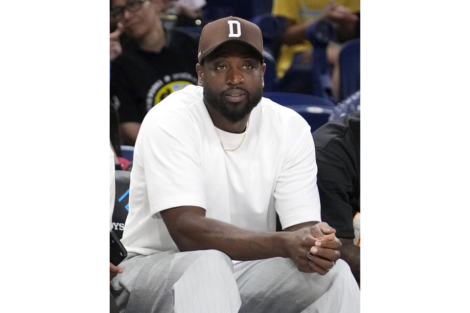 FILE - Dwyane Wade sits courtside before a game between the Sky and the Connecticut Sun, Wednesday, June 12, 2024, in Chicago. Dwyane Wade became a partial owner of the Chicago Sky last year. (AP Photo/Charles Rex Arbogast, File)