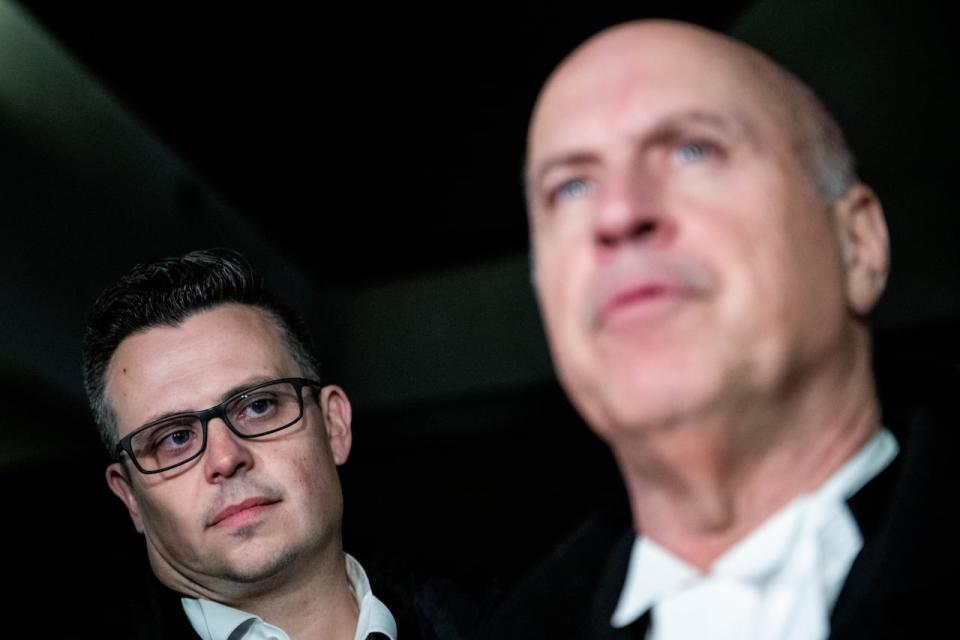 Defence lawyer Jon Doody looks on as fellow defence lawyer Mark Ertel speaks to reporters outside of the Ottawa Courthouse after Cameron Jay Ortis, a former RCMP intelligence official charged with breaching Canada's secrets law, was found guilty in Ottawa, on Wednesday, Nov. 22, 2023.