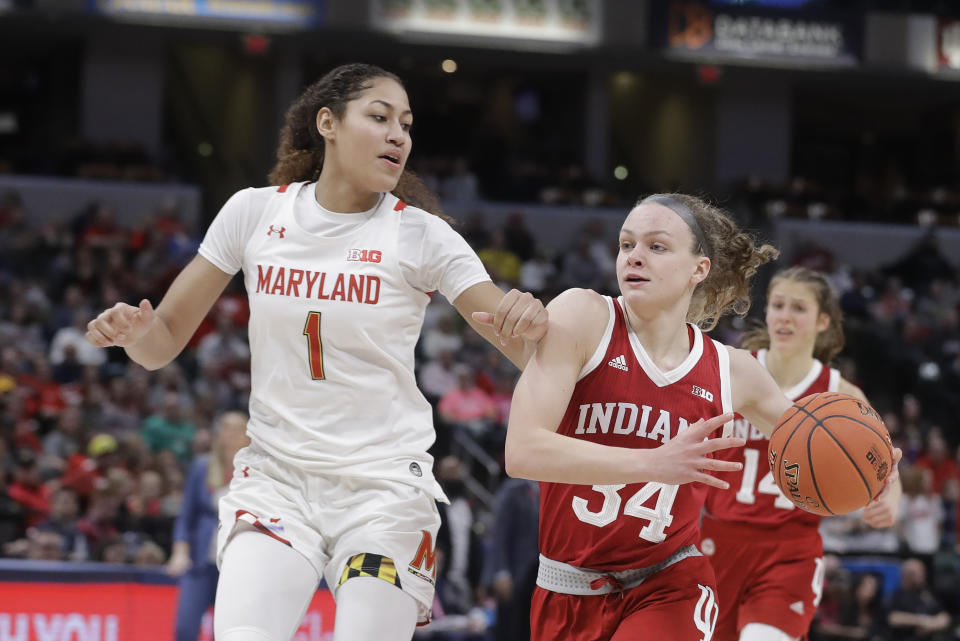 Indiana's Grace Berger (34) goes to the basket against Maryland's Shakira Austin (1) during the second half of an NCAA college basketball semifinal game at the Big Ten Conference tournament, Saturday, March 7, 2020, in Indianapolis. Maryland won 66-51. (AP Photo/Darron Cummings)