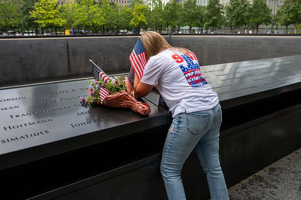 NEW YORK, NEW YORK - SEPTEMBER 10: A woman mourns by a name at the 9/11 Memorial and Museum at the Ground Zero site in lower Manhattan as the nation prepares to commemorate the 22nd anniversary of the attacks on September 10, 2023 in New York City. Monday will mark the 22nd anniversary of the September 11 terrorist attacks on the World Trade Center and the Pentagon, as well as the crash of United Airlines Flight 93. In total, the attacks killed nearly 3,000 people and commenced a global war on terror which included American led conflicts in both Iraq and Afghanistan.   (Photo by Spencer Platt/Getty Images)