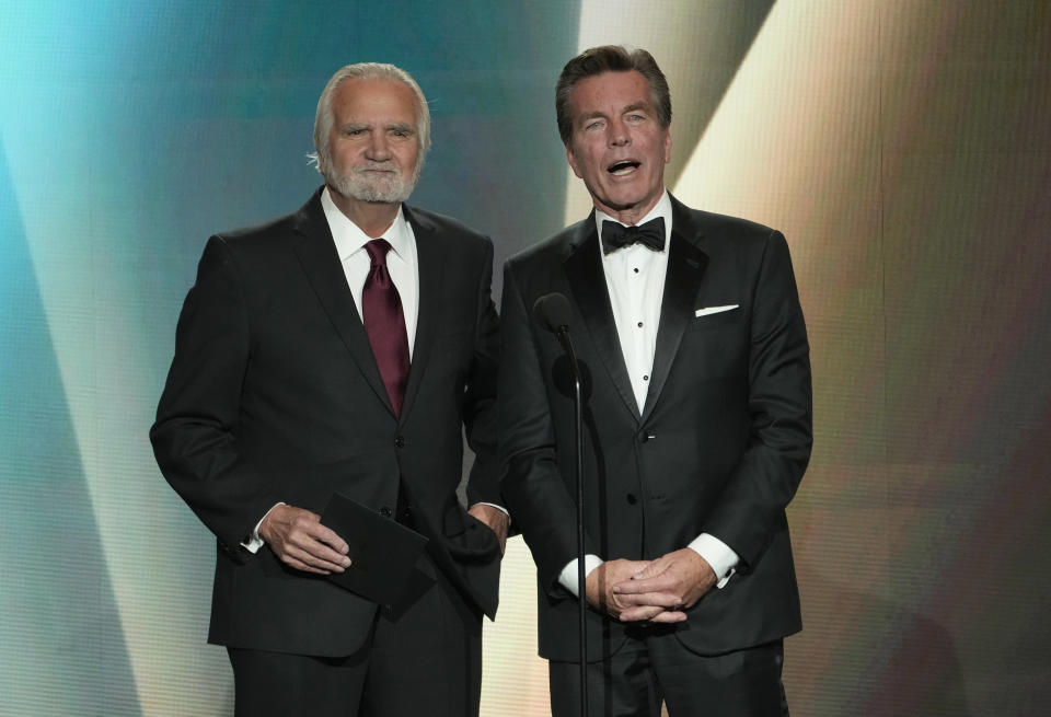 John McCook, left, and Peter Bergman present the award for outstanding performance by a lead actress in a daytime drama series during the 50th Daytime Emmy Awards on Friday, Dec. 15, 2023, at the Westin Bonaventure Hotel in Los Angeles. (AP Photo/Chris Pizzello)