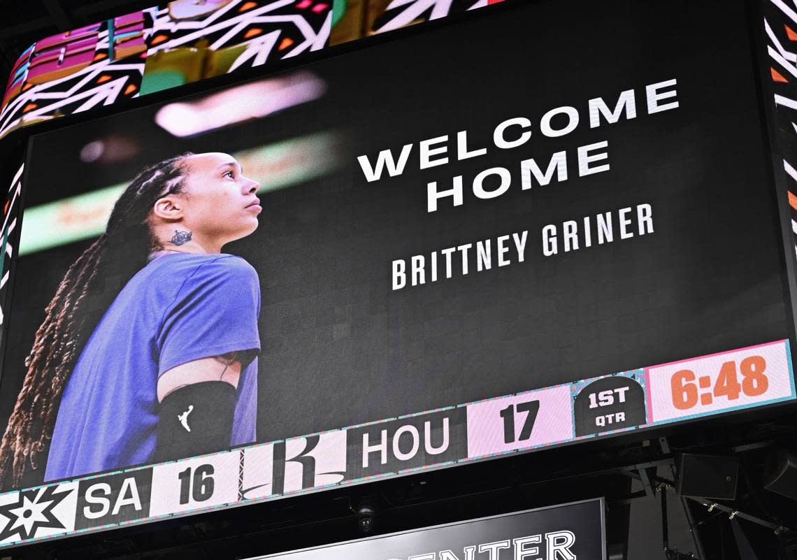 A graphic welcoming WNBA player Brittney Griner back to the United States, following her release in a prisoner swap with Russia, is shown on the scoreboard during an NBA basketball game between the Houston Rockets and the San Antonio Spurs, Thursday, Dec. 8, 2022, in San Antonio. (AP Photo/Darren Abate)