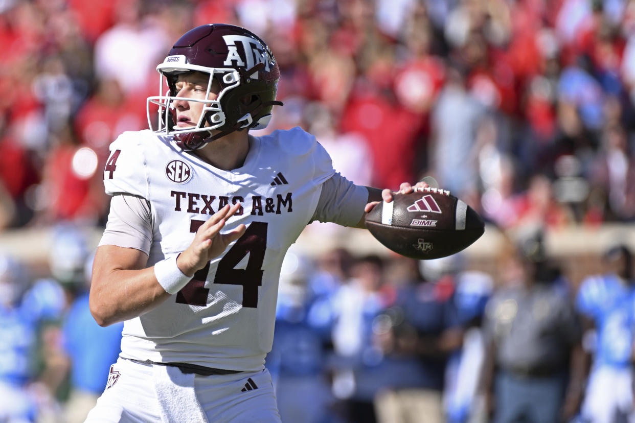 Texas A&M quarterback Max Johnson (14) looks to pass during the first half of an NCAA college football game against Mississippi in Oxford, Miss., Saturday, Nov. 4, 2023. (AP Photo/Thomas Graning)