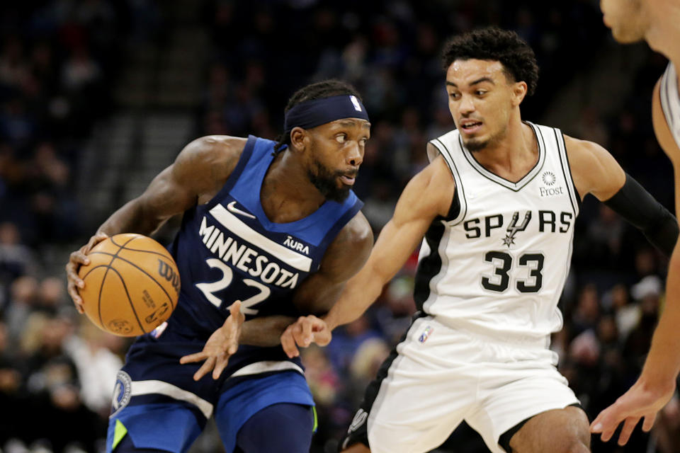 Minnesota Timberwolves guard Patrick Beverley (22) drives against San Antonio Spurs guard Tre Jones (33) in the first half of an NBA basketball game, Thursday, Nov. 18, 2021, in Minneapolis. (AP Photo/Andy Clayton-King)