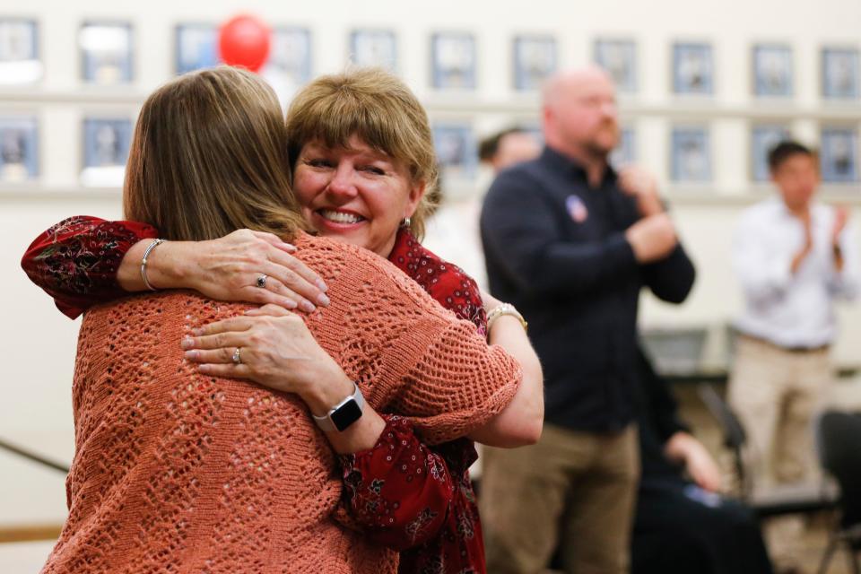 Board president Denise Fredrick gives a hug after results of the Springfield school bond issue came in Tuesday.