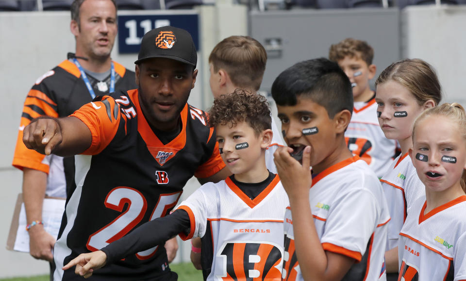 Player Giovani Bernard of the Cincinnati Bengals coaches a young team during the final tournament for the UK's NFL Flag Championship, featuring qualifying teams from around the country, at the Tottenham Hotspur Stadium in London, Wednesday, July 3, 2019. The new stadium will host its first two NFL London Games later this year when the Chicago Bears face the Oakland Raiders and the Carolina Panthers take on the Tampa Bay Buccaneers. (AP Photo/Frank Augstein)
