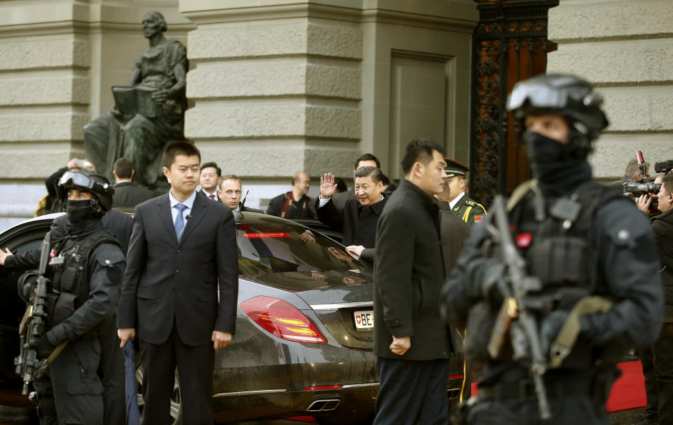 Chinese President Xi Jinping, center, waves as he leaves the Swiss federal parliament in Bern, Switzerland, on Sunday Jan. 15, 2017. Xi is on an official visit to Switzerland. (Arnd Wiegmann/Pool Photo via AP)