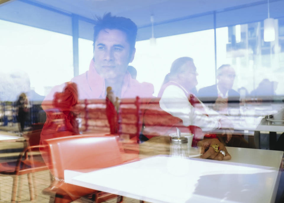 <p>Elvis tribute artist Des Perenara relaxes in a cafe between performances during ‘The Elvies’ in Porthcawl, Wales. 'The Elvies’ is an annual gathering of Elvis fans and tribute artists which takes place every September. (Photo: Getty Images)</p>