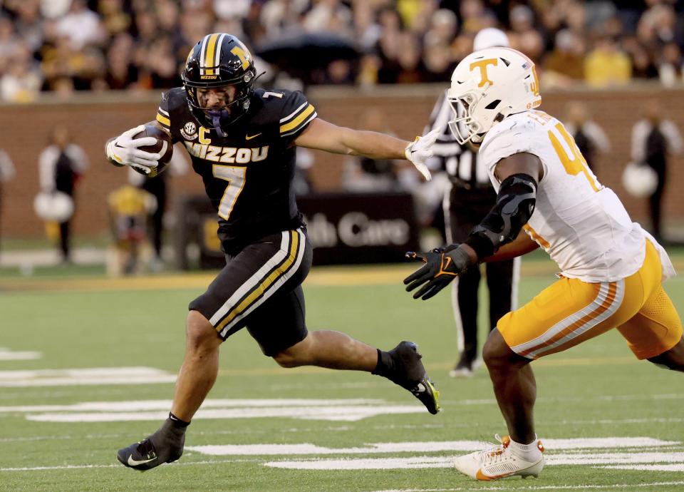 Missouri running back Cody Schrader holds off Tennessee linebacker Elijah Herring on a run during the second half of an NCAA college football game Saturday, Nov. 11, 2023, n Columbia, Mo. (David Carson/St. Louis Post-Dispatch via AP)