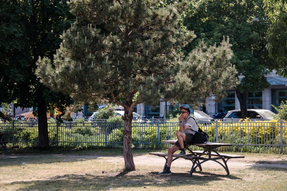 A man sits in the shade in the Old Port of Montreal during a heatwave in Montreal, Quebec, Canada, on June 1, 2023. Eastern Canada sweltered under a record-breaking heat wave on Thursday that risked inflaming wildfires ravaging the Atlantic coast and other parts of the country with