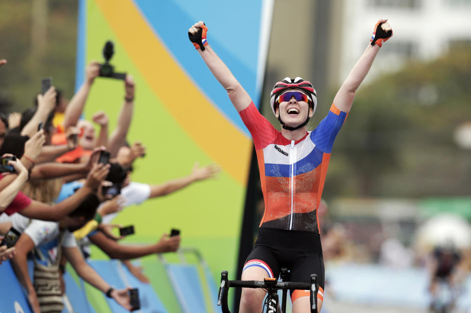 FILE - Anna Van Der Breggen, of the Netherlands, celebrates after crossing the finishing line to win the women's cycling road race final at the 2016 Summer Olympics in Rio de Janeiro, Brazil, in this Sunday, Aug. 7, 2016, file photo. The men's and women's road races kick off the cycling program at every Summer Olympics. “Everybody in the world is trying to figure out how to beat the Dutch girls,” said Jim Miller, the high performance director for USA Cycling. (AP Photo/Victor R. Caivano, File)