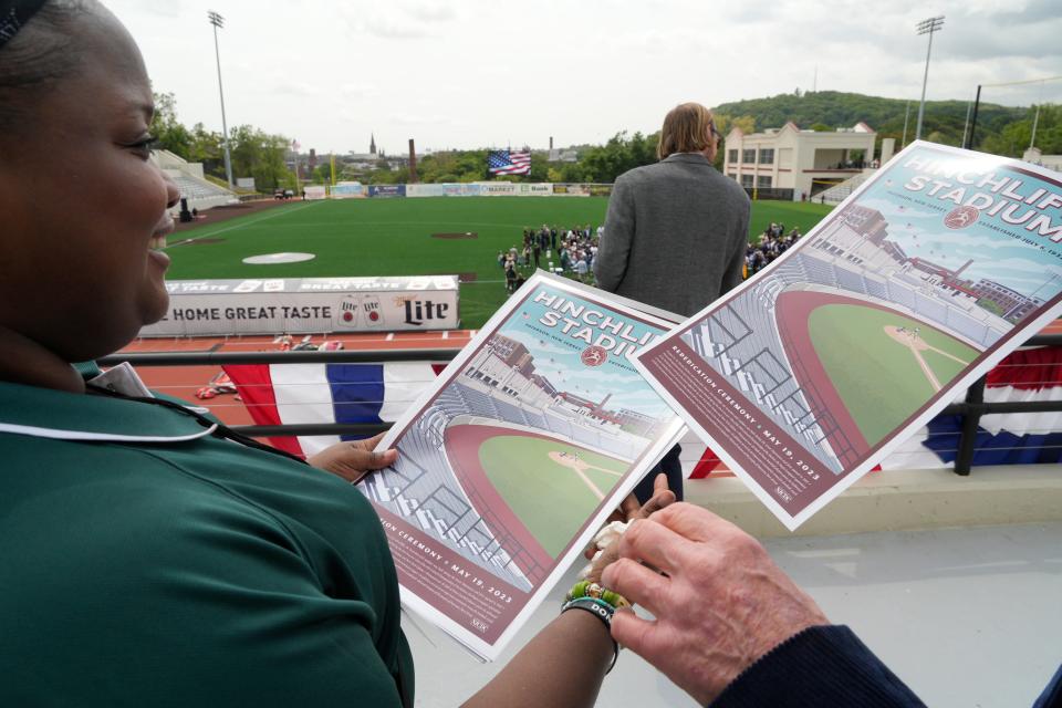 Destini Bell distributes posters to people attending the ribbon cutting. After years of neglect and abandonment Hinchliffe Stadium is being unveiled at a ribbon cutting in Paterson, NJ on Friday May 19, 2023. 