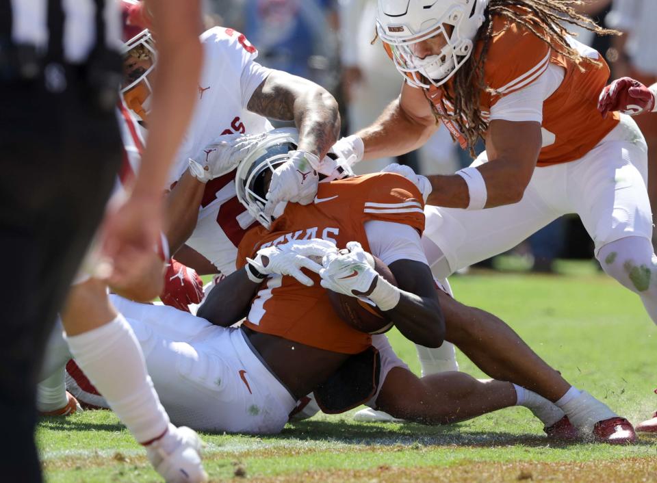 OU defensive back Billy Bowman Jr. (2) stops Texas receiver Xavier Worthy (1) short of the goal line on fourth down Saturday.