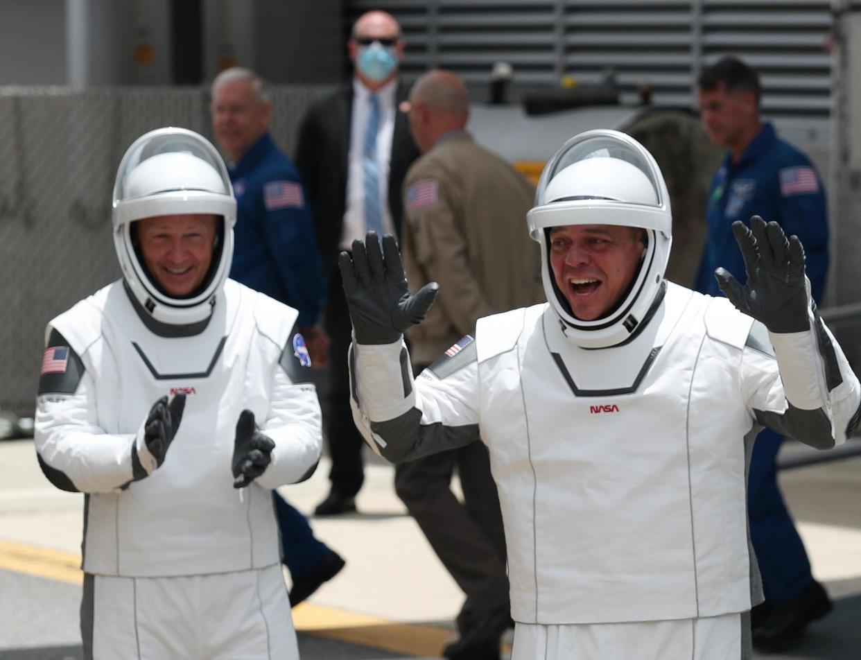 NASA astronauts Bob Behnken (R) and Doug Hurley (L) walk out of the Operations and Checkout Building on their way to the SpaceX Falcon 9 rocket with the Crew Dragon spacecraft on launch pad 39A at the Kennedy Space Center on May 27, 2020 in Cape Canaveral, Florida: Joe Raedle/Getty Images