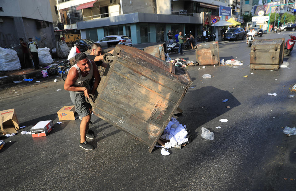 Saad Hariri's supporters block streets in Beirut, Lebanon, Thursday, July 15, 2021. Prime Minister-designate Saad Hariri says he is stepping down, nine months after he was named to the post by the parliament. He is citing "key differences" with the country's president, Michel Aoun. Thursday's announcement is likely to plunge the country further into more chaos and uncertainty. (AP Photo/Hussein Malla)