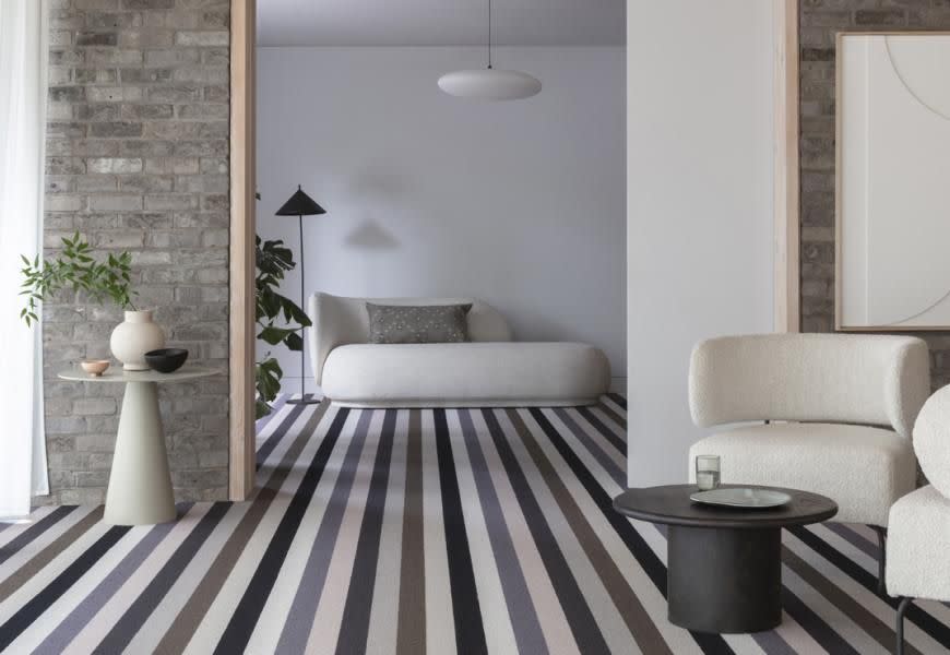 <p>A large scale stripe is a great way to establish your colour palette. Pick two or three shades from your carpet to inform the rest of your design scheme – here for instance a soft cream, chalky black and the lightest olive green have been used to create a sophisticated space. </p><p>Pictured: <a href="https://www.alternativeflooring.com/collection/wool/margo-selby-stripe/margo-selby-stripe-rock/reculver.html" rel="nofollow noopener" target="_blank" data-ylk="slk:Margo Selby Stripe Rock Reculver Carpet at Alternative Flooring;elm:context_link;itc:0;sec:content-canvas" class="link ">Margo Selby Stripe Rock Reculver Carpet at Alternative Flooring</a></p>