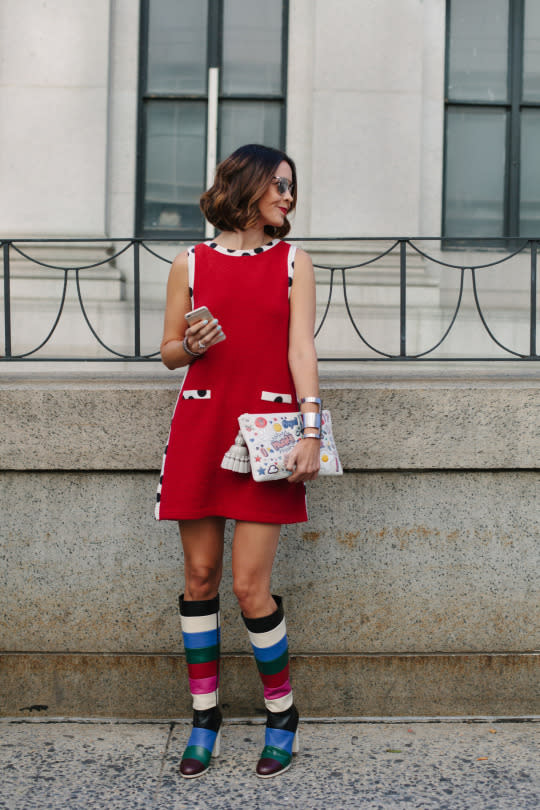 A street style star looks on in a red frock and striped boots at New York Fashion Week 2015. (Photo: Rex)