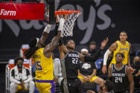 Los Angeles Lakers center Montrezl Harrell (15) goes to the basket as he's defended by Sacramento Kings center Richaun Holmes (22) during eth second quarter of an NBA basketball game in Sacramento, Calif., Wednesday, March 3, 2021. (AP Photo/Hector Amezcua)