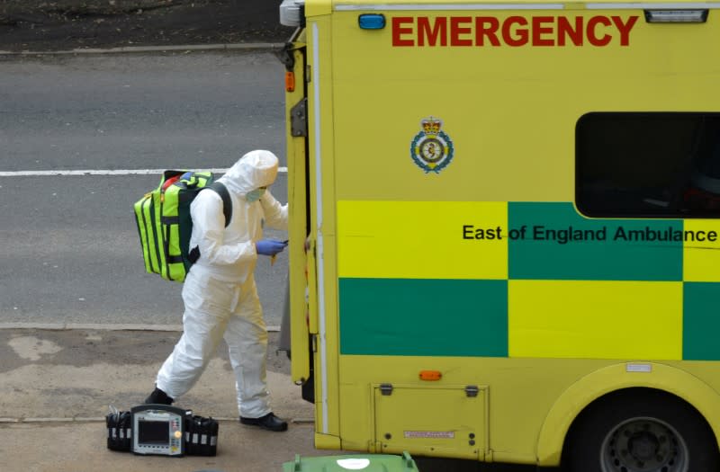 FILE PHOTO: A paramedic is seen in Cheshunt at the back of an ambulance as the spread of the coronavirus disease (COVID-19) continues