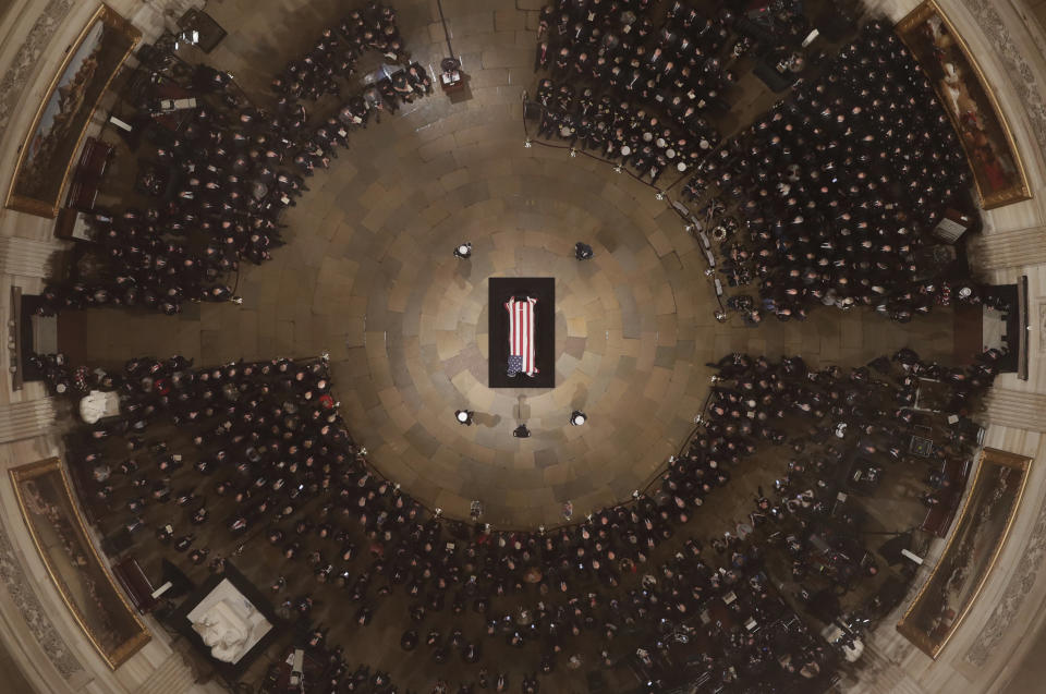 A military honor guard and mourners surround&nbsp;the casket.&nbsp;