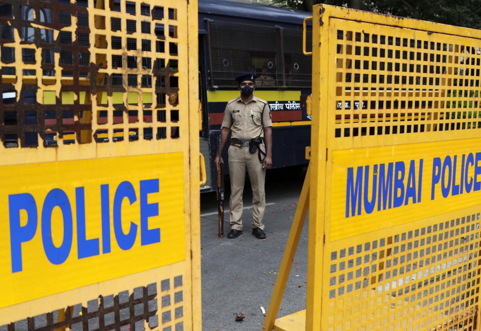 Policemen guard outside Chinese consulate anticipating protests in Mumbai, India, Wednesday, June 17, 2020. Indian security forces said neither side fired any shots in the clash in the Ladakh region late Monday that was the first deadly confrontation on the disputed border between India and China since 1975. China said Wednesday that it is seeking a peaceful resolution to its Himalayan border dispute with India following the death of 20 Indian soldiers in the most violent confrontation in decades.(AP Photo/Rajanish Kakade)