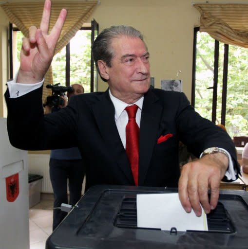 Albanian Prime Minister and Democratic Party leader Sali Berisha makes a victory sign as he casts his ballot at a polling station in Tirana on June 23, 2013