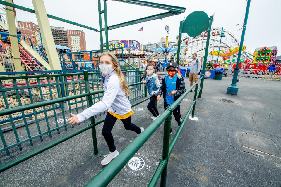 Children run to be some of the first guests to enjoy the rides as Coney Island Amusement Parks reopens after 18 months due to the coronavirus pandemic on April 9, 2021 in New York City.  / Credit: Roy Rochlin/Contributor/Getty Images