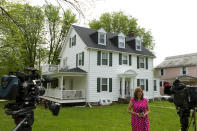 TV crews report form outside the house of Baltimore Mayor Catherine Pugh in Baltimore, MD., Thursday, April 25, 2019. Agents with the FBI and IRS are gathering evidence inside the two homes of Pugh and also in City Hall. (AP Photo/Jose Luis Magana)