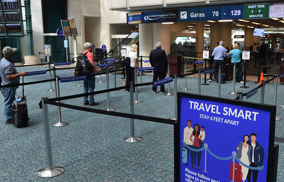 A sign reminding passengers to stay six feet apart at a screening checkpoint at Orlando International Airport on May 21, 2020.  (Photo: SOPA Images via Getty Images)