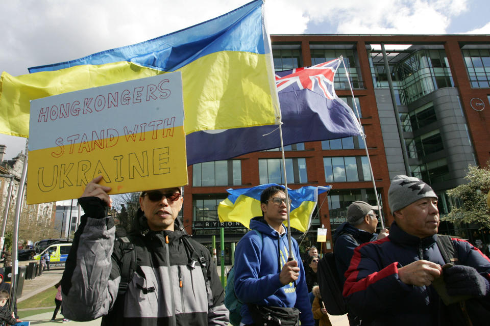 A member of the "Hong Kong" community in Manchester, England shows solidarity with Ukraine and its people during a protest around Manchester's city center on April 9.<span class="copyright">Andrew McCoy—SOPA Images/LightRocket/Getty Images</span>
