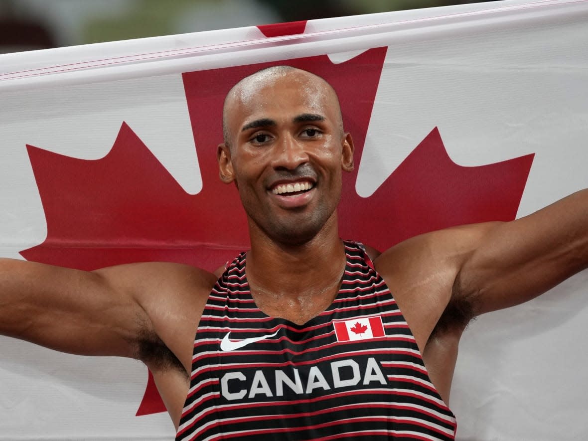Canada's Damian Warner, seen above celebrating winning gold in the Olympic decathlon, won the Lou Marsh Trophy as Canada's top athlete in 2021 on Wednesday. (Matthias Schrader/The Associated Press - image credit)